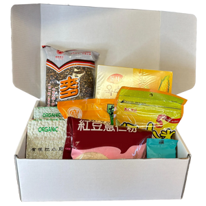 Top-down view of Qi Reset™ Ritual Kit with Chinese medicine–inspired meal contents displayed in white box