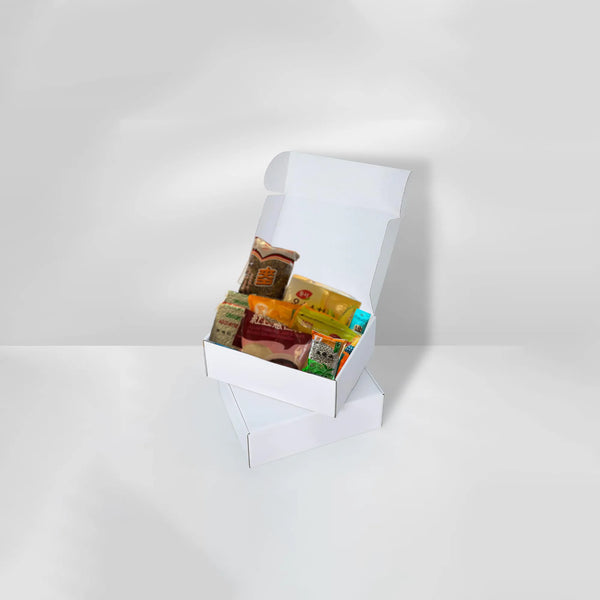 Two Qi Reset™ Ritual Kits stacked on beige table, top box open to reveal Traditional Chinese Medicine–based contents